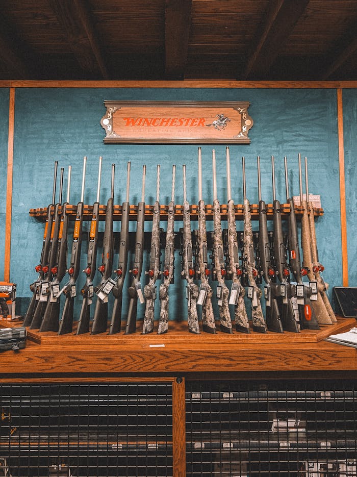 A collection of rifles neatly arranged on a rack in a Winchester store in St. Augustine, Florida.